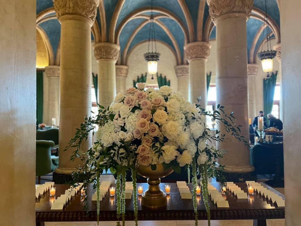 Escort Cards on table with large centerpiece in the center.